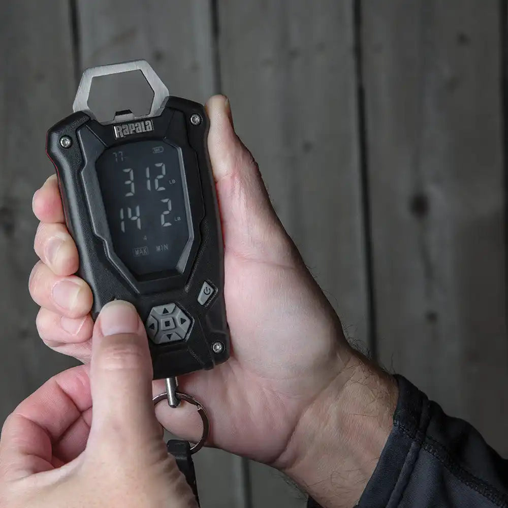 Digital stopwatch or timer device being held in someone’s hands.