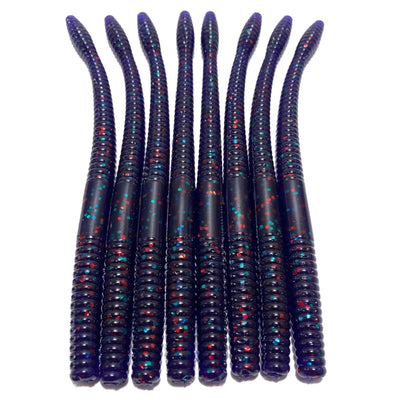 Purple plastic fishing worms with red and blue flecks arranged in a row.